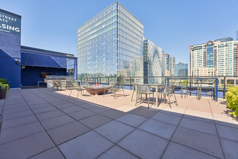 a terrace with tables and chairs on top of a building